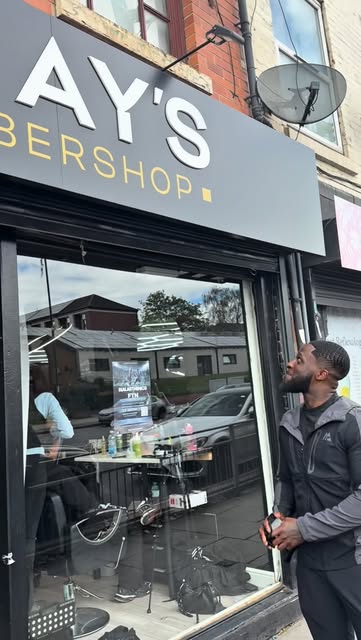 Shopfront signage of MJay's Barbershop on Carlton Road, Nottingham