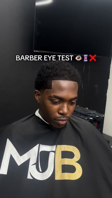 Client caped in the MJB gown mid-haircut
